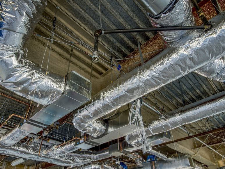 insulated air ducts across ceiling of commercial building